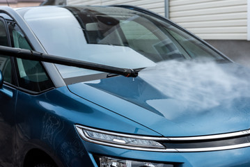 Fototapeta premium Process of car washing using high pressure water.