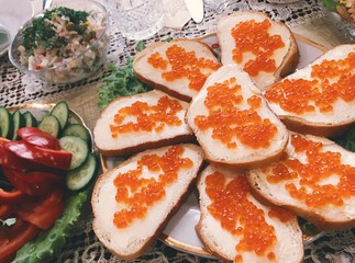 Red caviar russian traditional sandwiches with butter on the table. Happy New year celebration