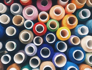 Tops of coils of colorful sewing threads