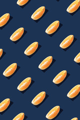 Flat lay pattern with summer orange fruit on blue background. Minimal concept with sharp shadows. Trendy social mockup or wallpaper.