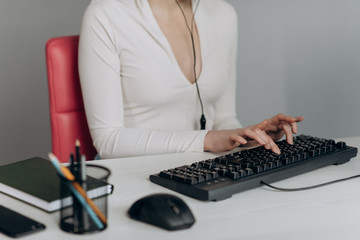 Woman hands coding html and programming on screen laptop, development web, developer. Female hands type on keyboard. No face woman sits on sofa freelancing working at home writes in social networks