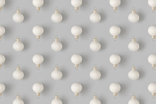 Christmas pattern with white bauble decaration on pastel gray background. Minimal holiday concept.