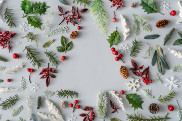 Christmas tree pattern with winter pine tree, natural branches and leaves on pastel gray background. Minimal holiday concept.