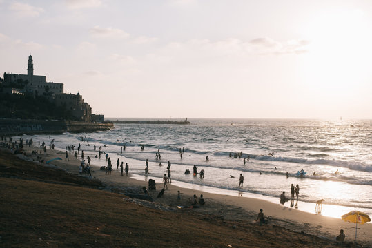 HIGH ANGLE PEOPLE ON BEACH ON SUNSET IN TEL AVIV  YAFFA ON BACKGROUNFD