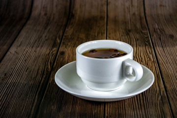 Coffee beans falling in the coffee mug