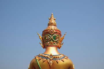 Back of golden status in temple thailand