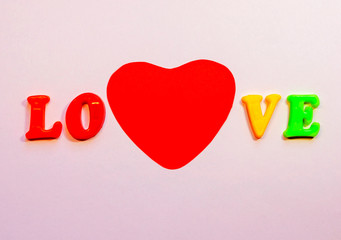 Big red heart and the word love made of colored letters with copy space. Postcard congratulation on Valentine's Day, February 14