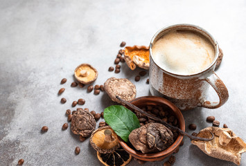 Obraz na płótnie Canvas Mushroom coffee, a ceramic cup, mushrooms and coffee beans on stone concrete background. New Superfood Trend.