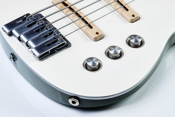 White bass guitar details on a white background with copy space