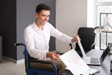 Handicapped young man working in office