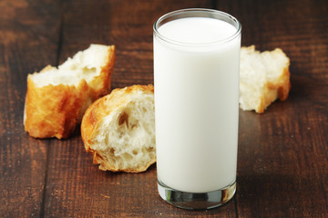 A glass of milk and wheat bread as countryside breakfast	