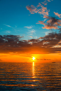 Amazing Sunset view at Indian ocean  Colorful nature scenery orange and blue shade cloudy sky, Vertical sea sunset background image