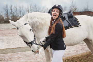 Happy girl and white horse outdoors