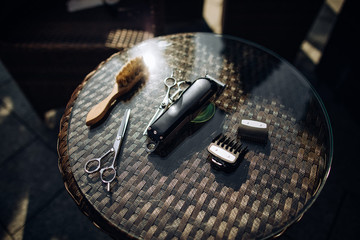 Barber, Hairdresser's tools: scissors, comb, brush, trimmer on the table