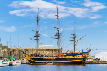 Etoile du Roy, a three-masted sixth-rate frigate, warship moored to the harbour of Saint-Malo