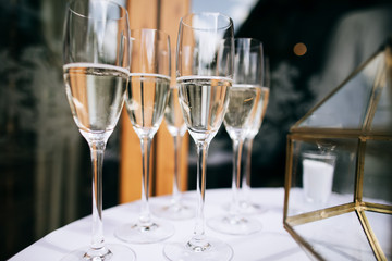 glasses of champagne on table on wedding reception in restaurant