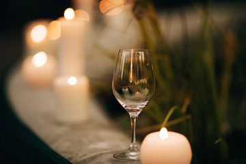 Wine glass at wedding ceremony in candlelight garden