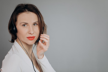 Support phone operator in headset using personal computer. Agent Woman Smiling in Call Center...