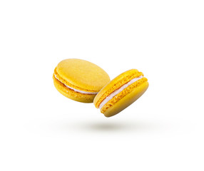 Lemon yellow macaroons are flying on a white background.