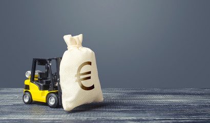 Yellow forklift carries a Euro money bag. Grants financing. Payment of taxes. Big contract, profitable deposit, take a loan. Inflation, price increases. Wealth, investments in economy. financial aid © Andrii Yalanskyi