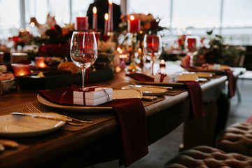 Beautiful, decorated table with flowers and red candles. Luxury Christmas evening or wedding party decoration.