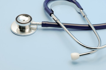 Stethoscope for doctor checkup on light blue background with copy space, healthcare and medical concept.