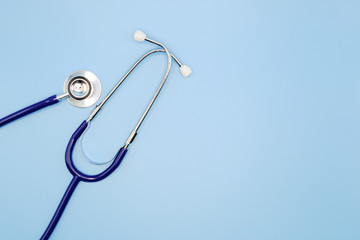 Flat lay of stethoscope for doctor checkup on light blue background with copy space, healthcare and medical concept, top view photo.