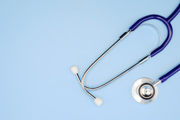 Flat lay of stethoscope for doctor checkup on light blue background with copy space, healthcare and medical concept, top view photo.