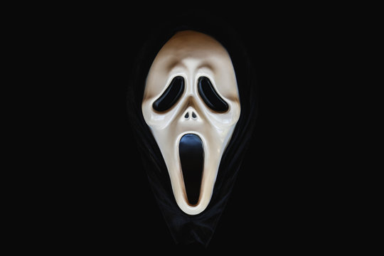 BANGKOK, THAILAND, 26 Jan 2020: Close-up of screaming carnival mask object on a black background