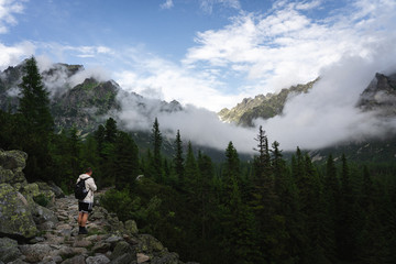 Beautiful scenery of High Tatras mountains in Slovakia with man admiring it