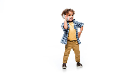 positive african american boy talking on smartphone, isolated on white