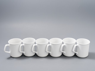 white cups for sublimation in composition on a gray background