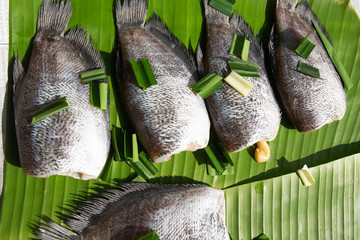 Set of sun dried gourami fish on Banana leaf
