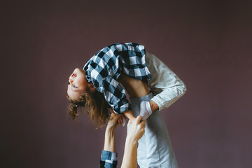 Little girl does an acrobat exercise with her mother. Closeup portrait