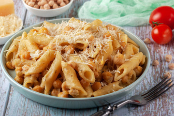 Italian pasta with chickpeas, spices and tomatoes - closeup