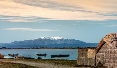 Historic fishing village and the Etang de Canet lagoon and Canigou in the background