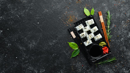 Delivery of sushi. Sushi, maki with cream cheese and avocado. Top view. © Yaruniv-Studio