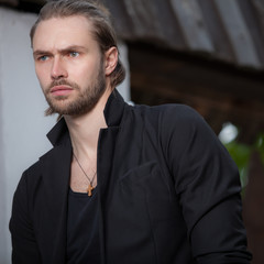 Young elegant handsome man posing outside.