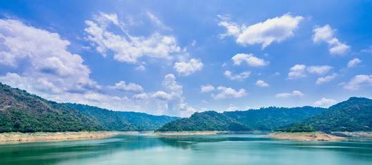 Beautiful view water in lake and high mountain with blue cloudy sky behind khun dan prakan chon dam in nakhon nayok province thailand