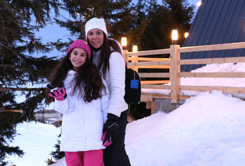 Mom and daughter having fun on winter vacation
