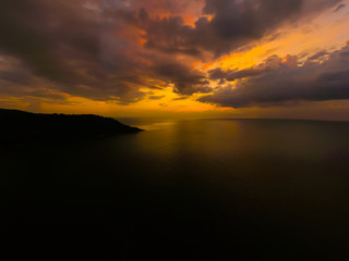 Aerial view of sunset over the sea , Phuket, Thialand. Sunset of sun setting over ocean. Tranquil idyllic scene of a golden sunset over the sea with reflection.
