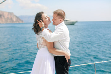 Family on honeymoon while on holiday on a sea sailing yacht in the open sea.