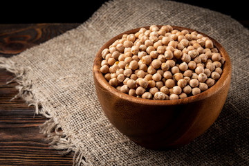 Chickpea on dark wooden background.