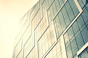 Modern office building facade abstract fragment, shiny windows in steel structure. Architecture with sun ray. Retro stylized colorful tonal filter effect.