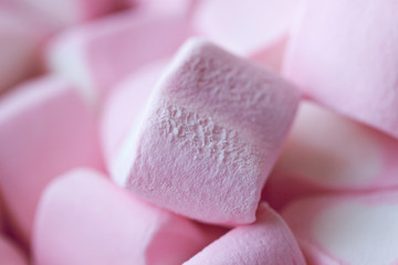 Heap of marshmallows in the shape of hearts on a pink background. The concept of St. Valentine's Day, love, sweets