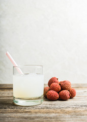 Old fahioned lychee cocktail on the rustic background. Selective focus. Shallow depth of field.