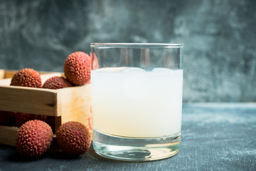 Old fahioned lychee cocktail on the rustic background. Selective focus. Shallow depth of field.