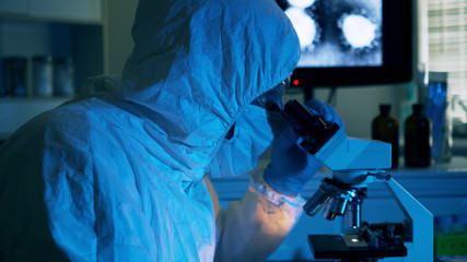 lab tech looking at a blood sample of Wuhan Coronavirus virus