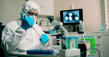 lab tech with sample of Wuhan Coronavirus virus