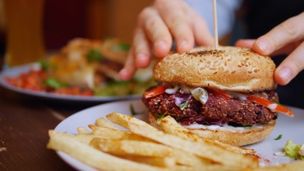 Eating Healthy Vegan Burger With French Fries . Closeup.